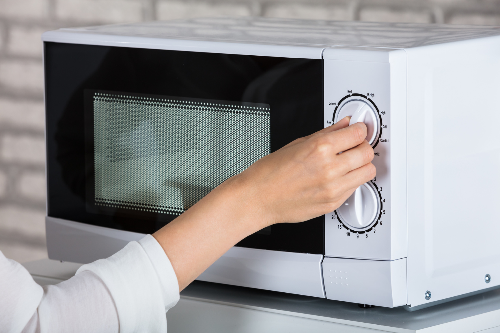Woman Using Microwave Oven